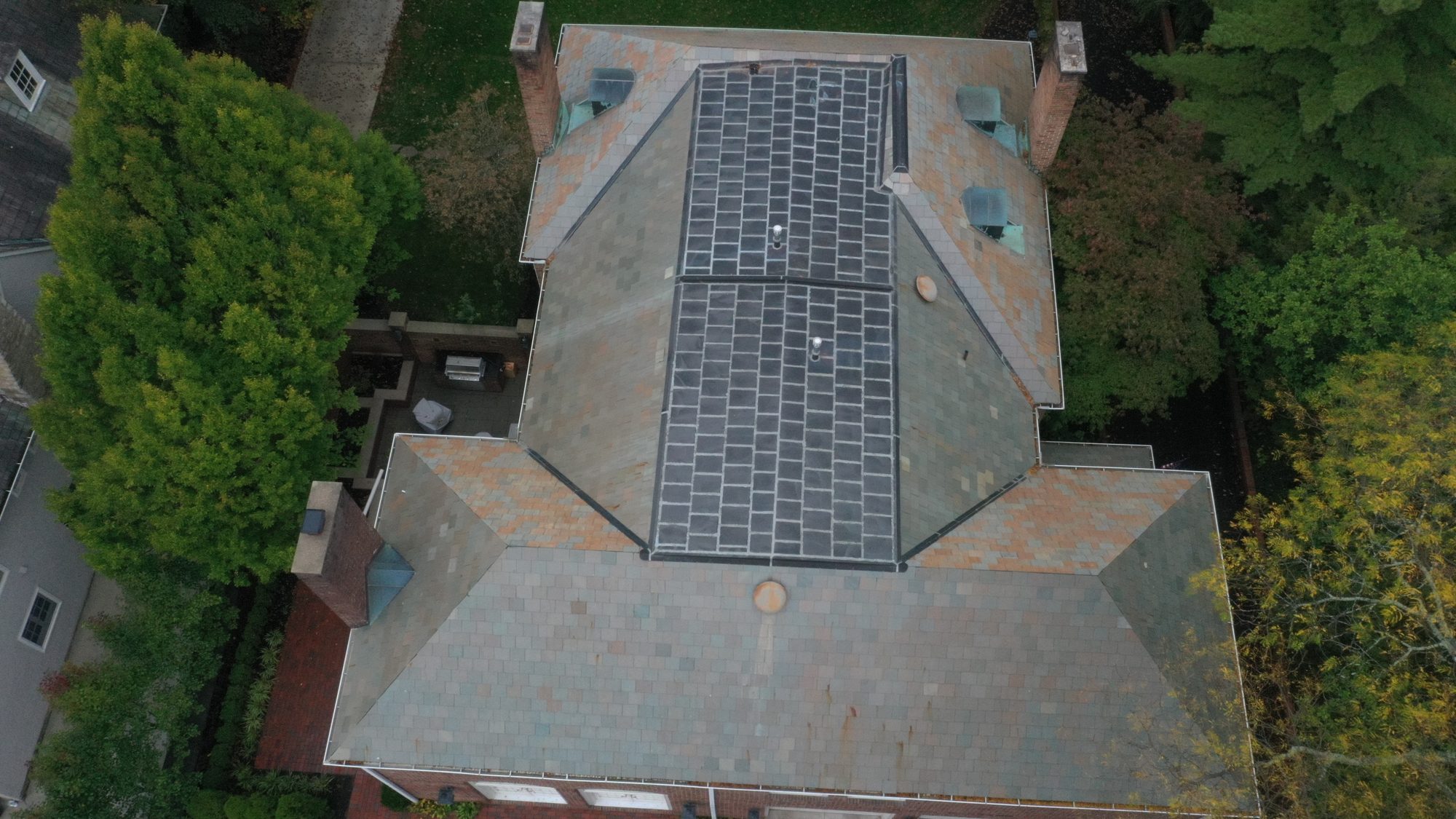 Slate roof around brick chimney in Bexley after professional cleaning by Forza