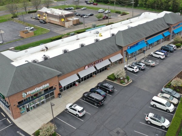 Commercial roof with heavy algae and biological growth before cleaning