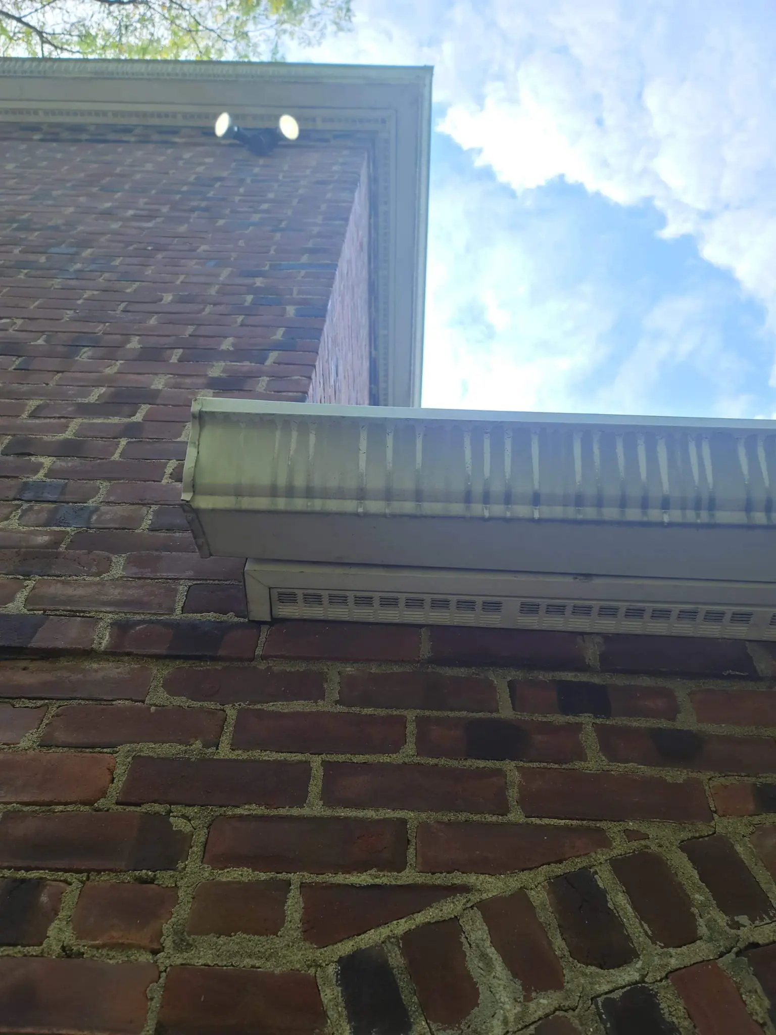 Gutters packed with leaves and debris before Forza cleaning