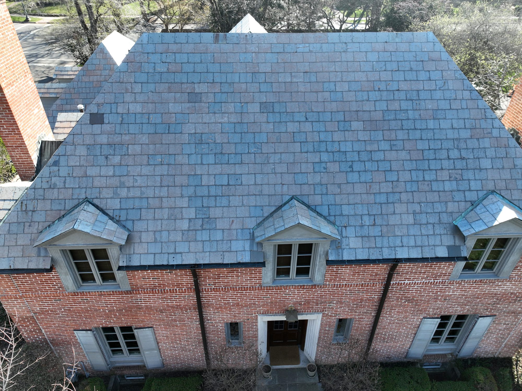 Drone shot of restored slate roof with clean dormers in Bexley Ohio