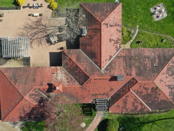 Tile roof with heavy algae and dark staining before cleaning