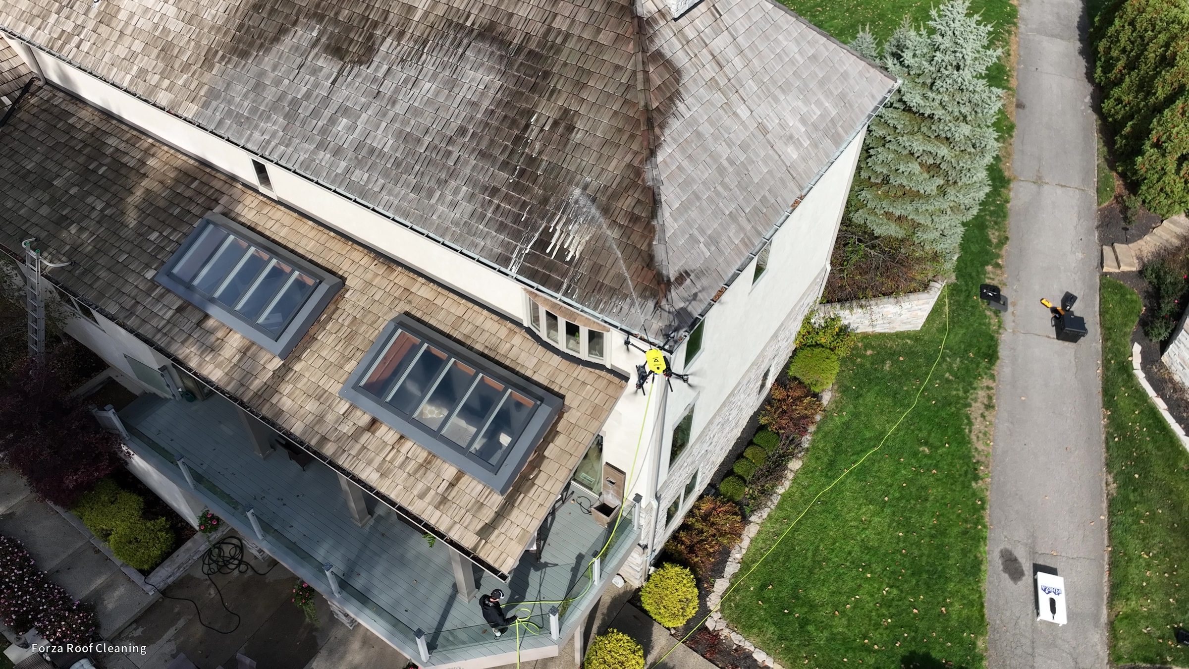 4K drone still showing Forza van in driveway while washing drone works on cedar shake roof above, Muirfield Village Dublin Ohio