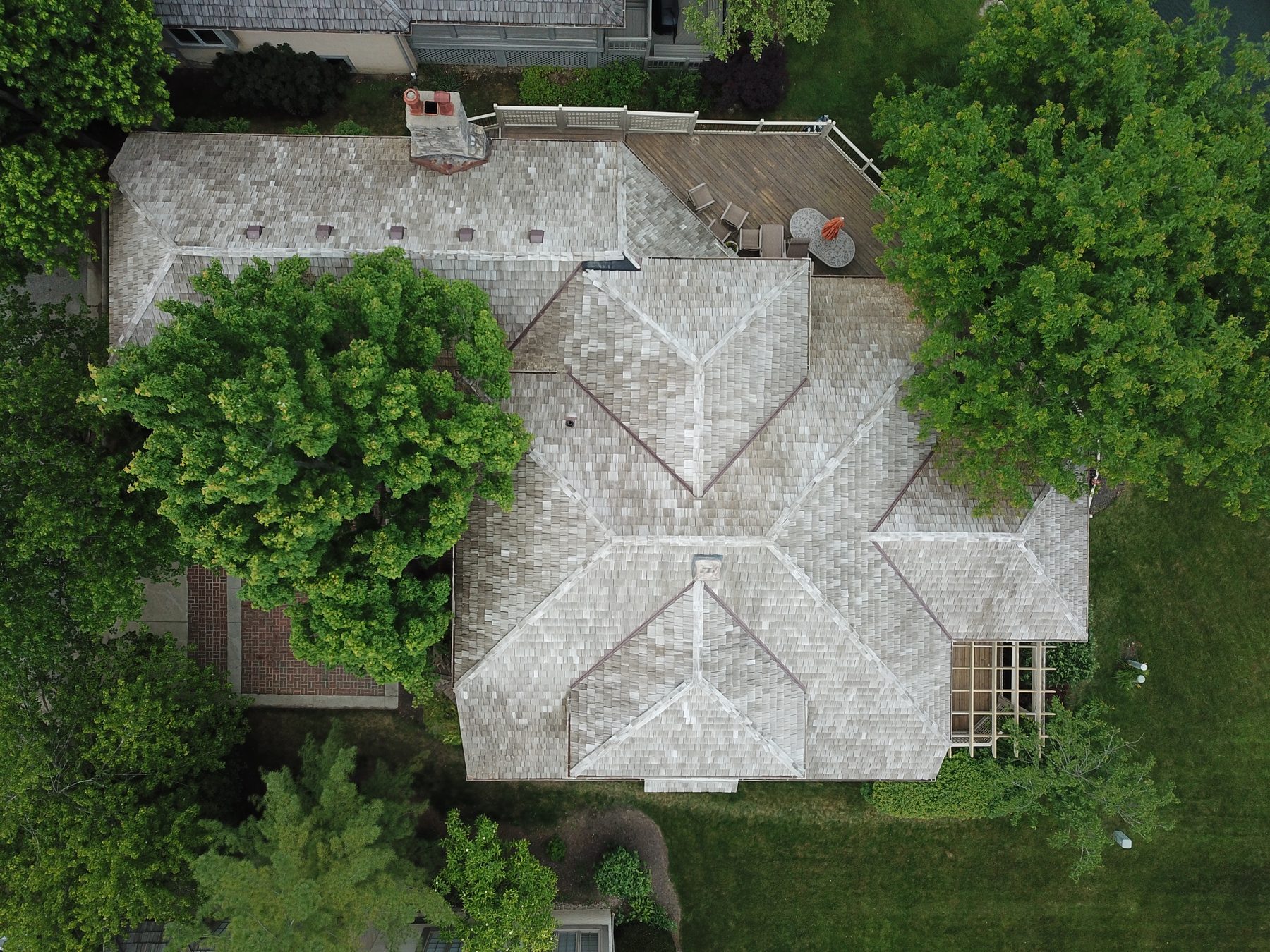 After cedar roof cleaning - chimney area with restored cedar shakes in Muirfield Village Dublin Ohio