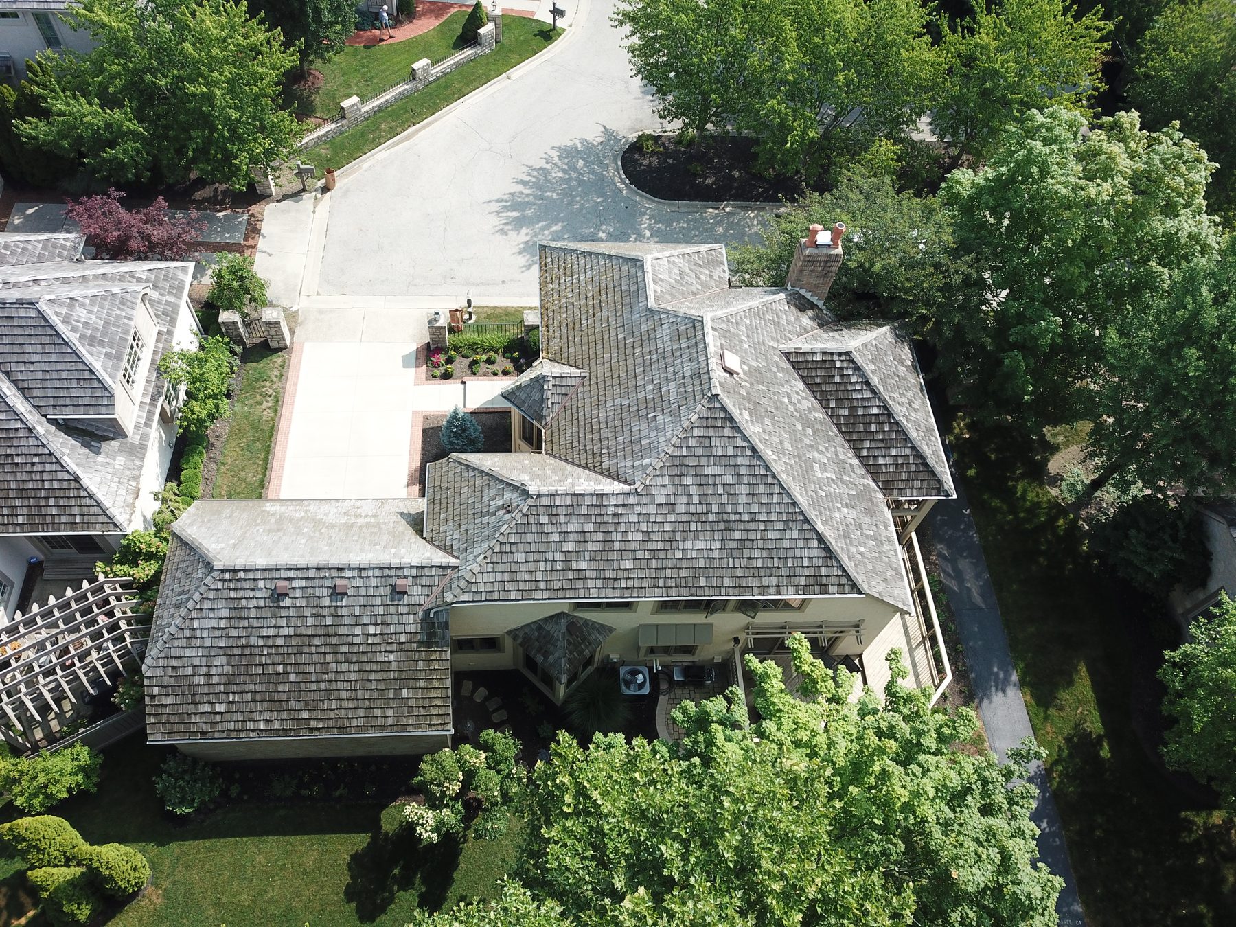 Before cedar roof cleaning - overhead view of cedar shake roof with moss algae and black streaks on cul-de-sac home in Muirfield Village Dublin Ohio