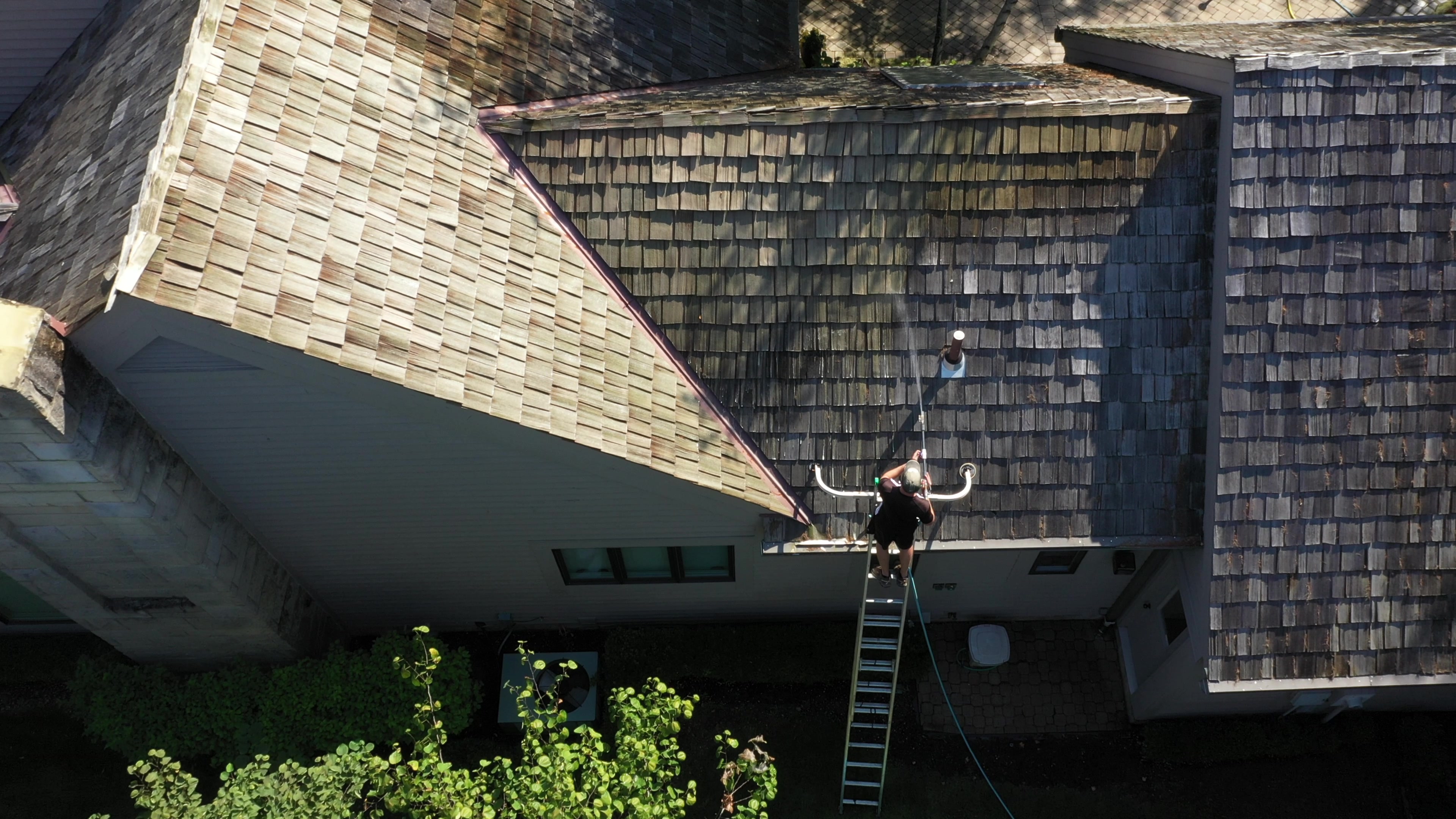 Cedar shake roof cleaning process - estate home treated vs untreated contrast in The Quarry Dublin