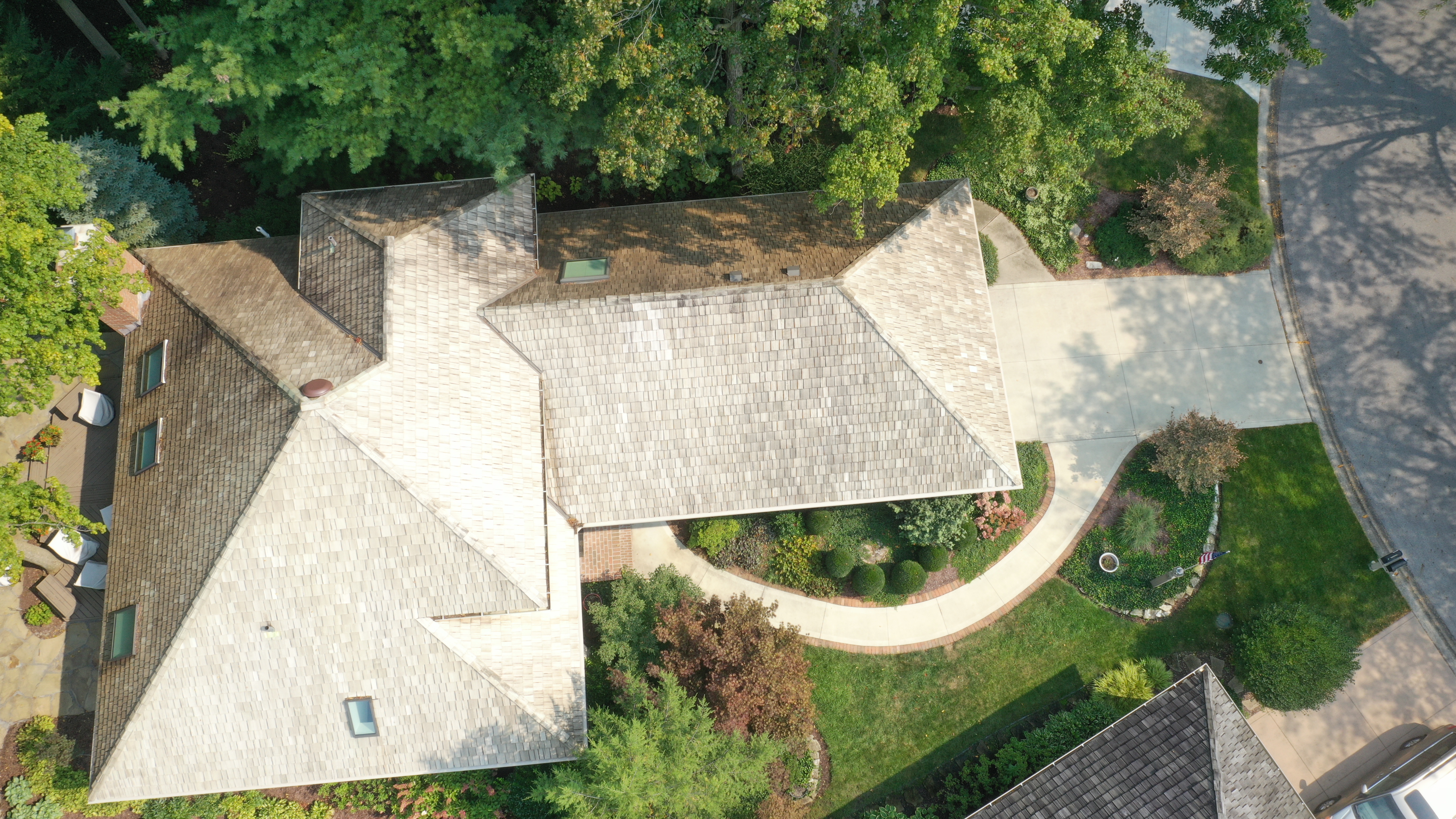 After cedar roof cleaning - overhead view of massive estate cedar shake roof restored to golden-tan, same curved driveway and landscaping, The Sanctuary Columbus Ohio