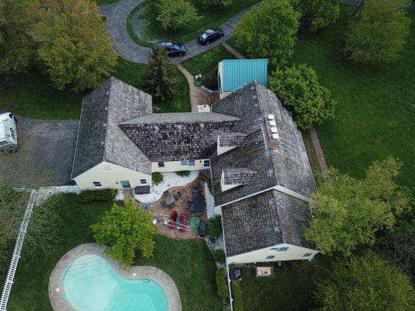 Cedar shake roof darkened with algae and mold before cleaning