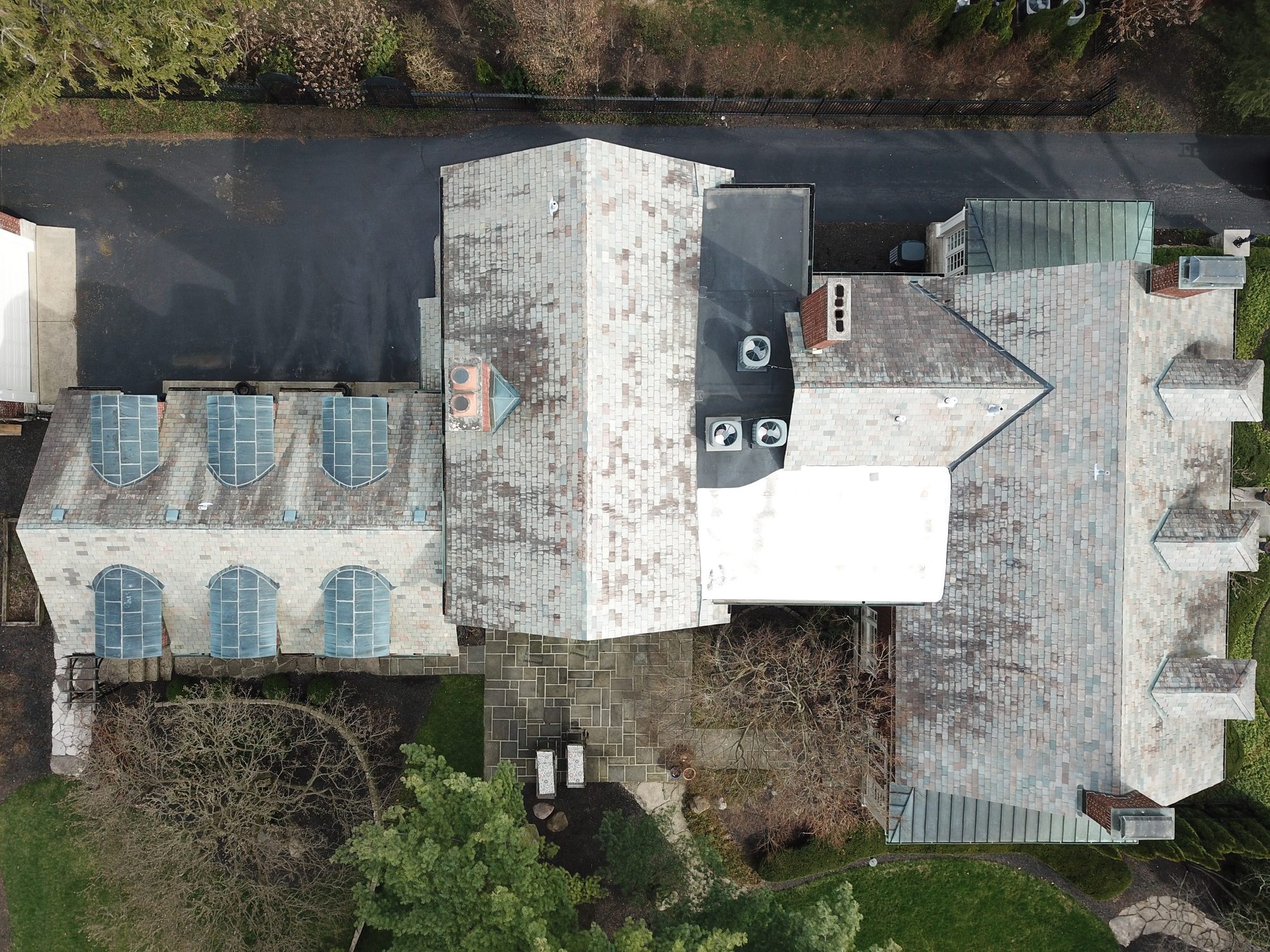 Side view of Bexley slate roof with algae before cleaning