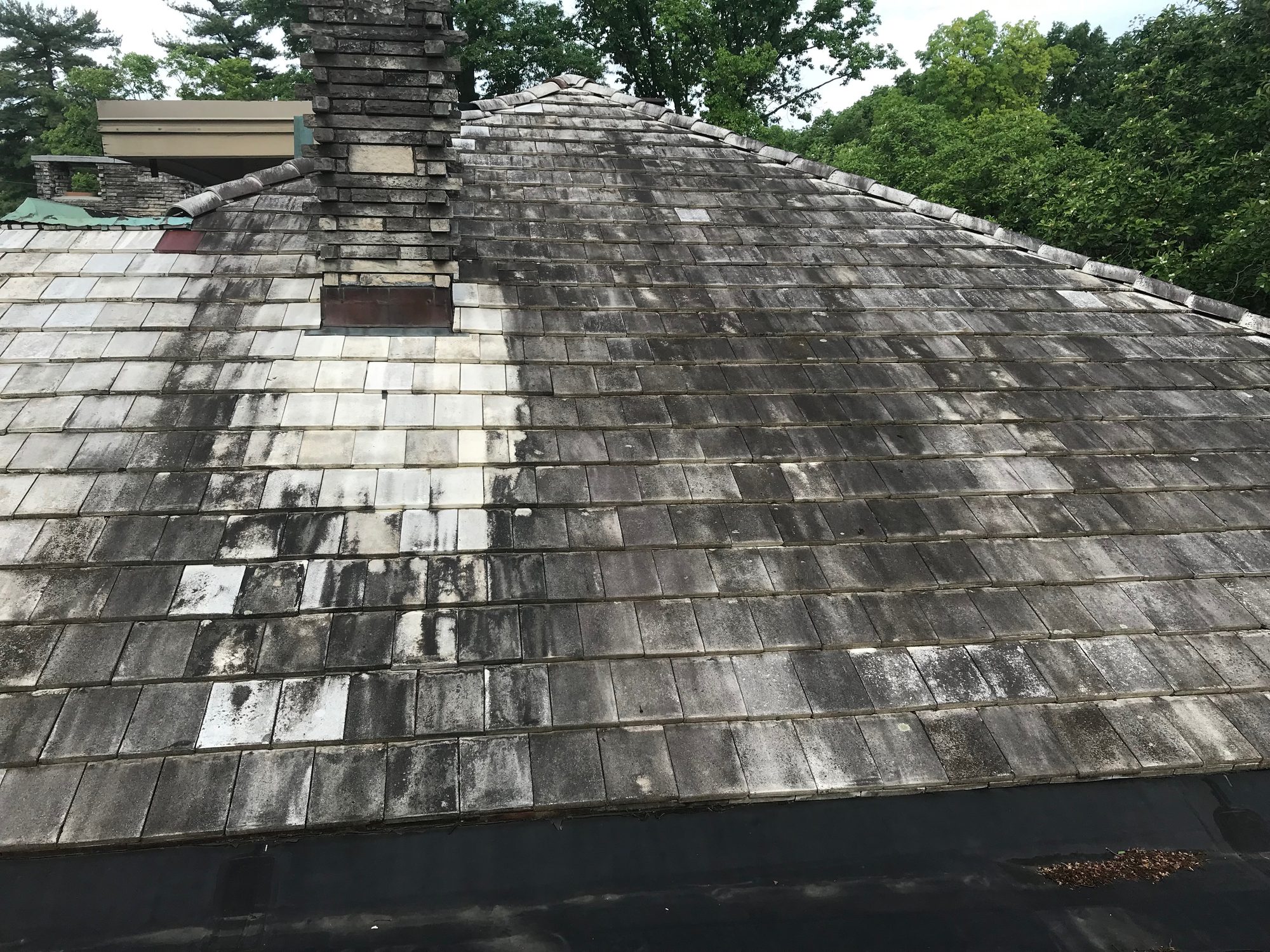 Tile roof in Bexley Ohio before cleaning showing heavy black algae streaks on concrete tiles