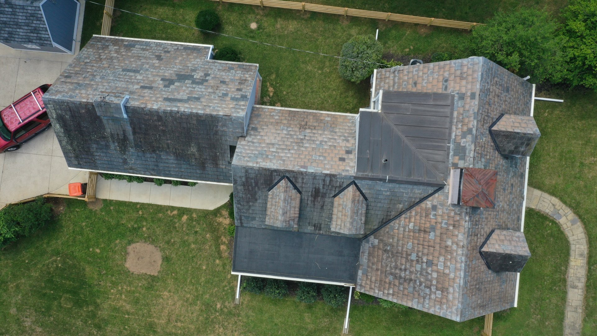Before roof cleaning in Heath Ohio — heavy algae and moss on complex multi-level shingle roof