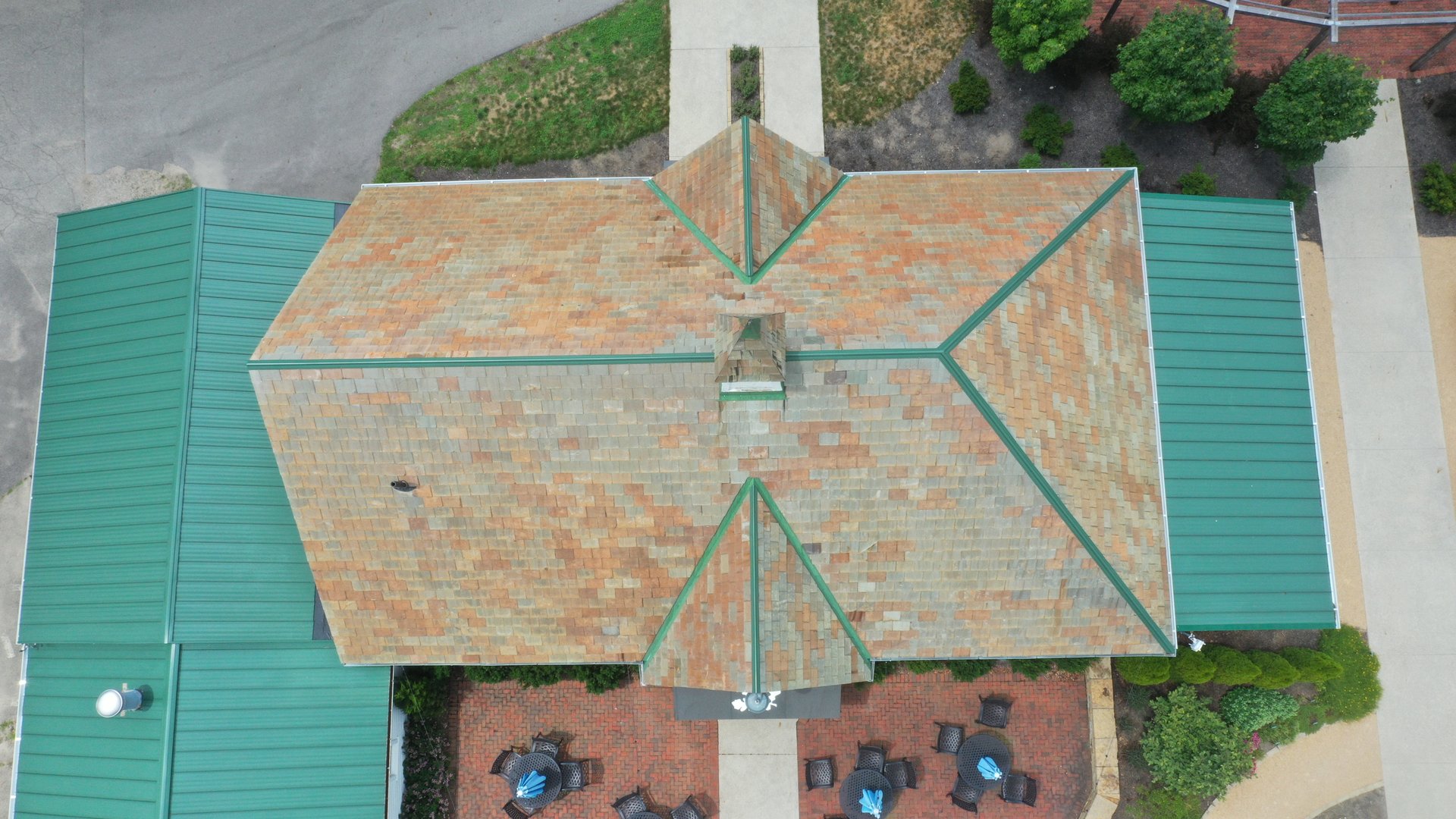 After roof cleaning in Newark Ohio — restored warm terracotta slate tiles on commercial building