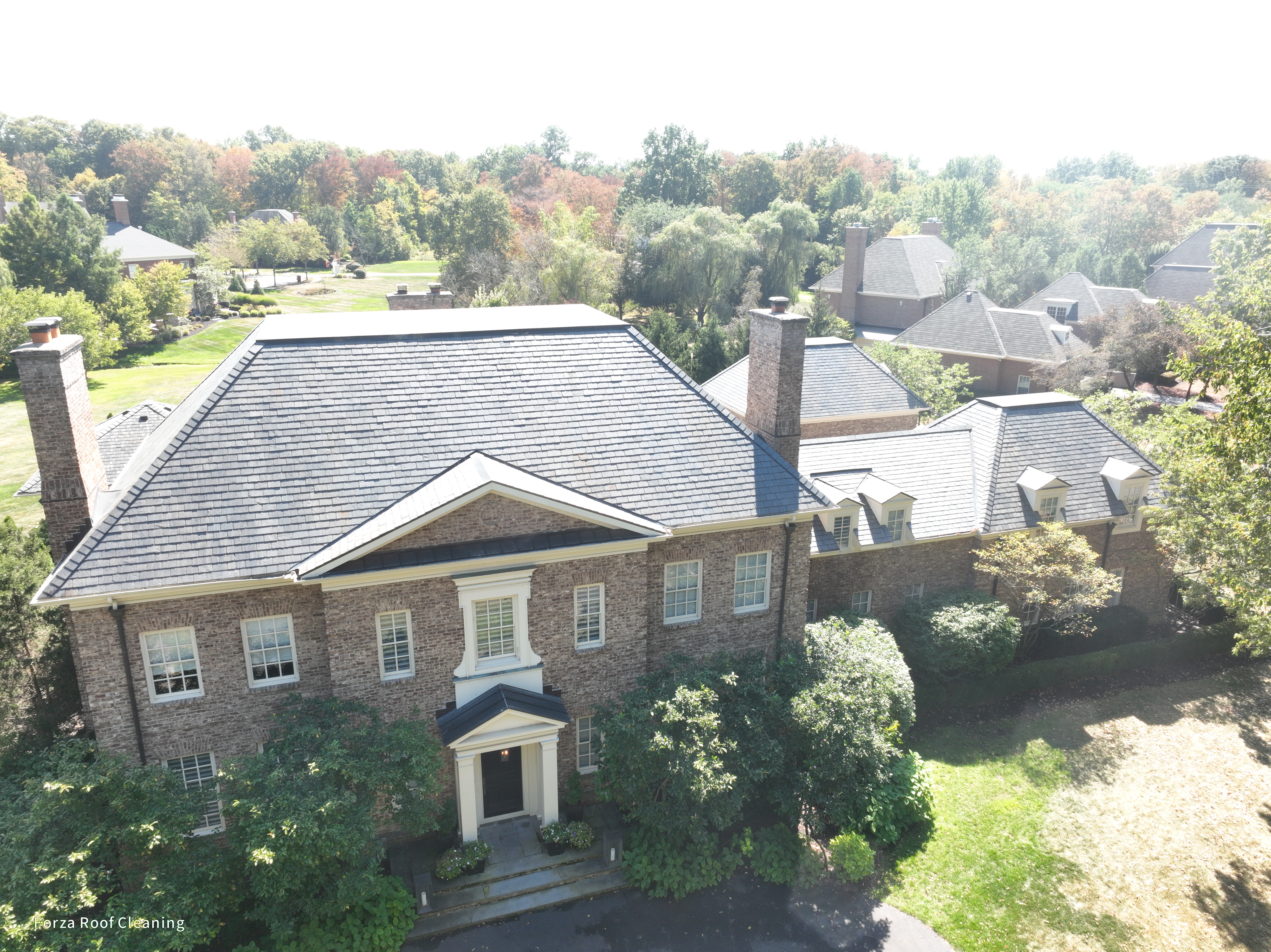 Luxury estate slate roof cleaning results in New Albany Ohio with pool and dormers